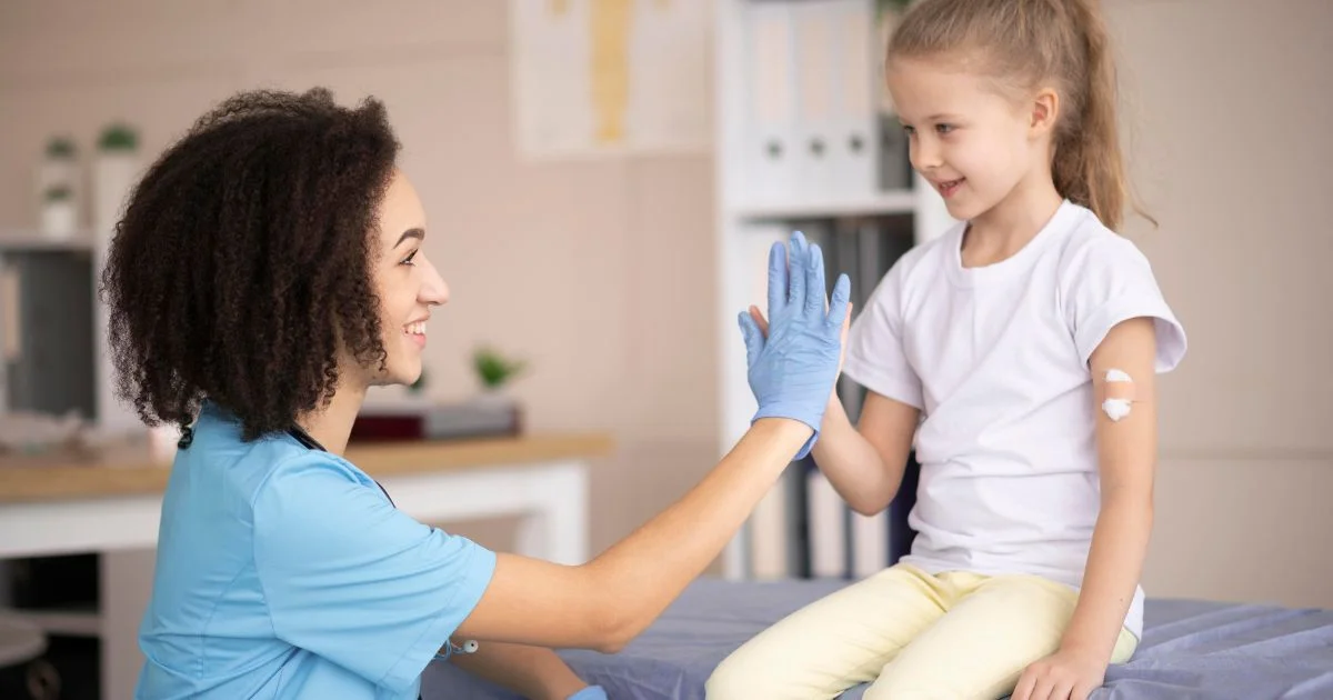 Nurse high-fiving child after vaccination